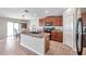 A spacious kitchen featuring an island with seating, dark wood cabinets, and modern appliances at 4201 Globe Thistle Dr, Tampa, FL 33619