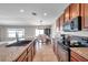 Bright kitchen featuring dark wood cabinets, granite countertops, and stainless steel appliances at 4201 Globe Thistle Dr, Tampa, FL 33619