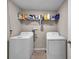 Laundry room with a wire shelf and white washer and dryer at 4201 Globe Thistle Dr, Tampa, FL 33619