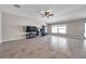 Open living area with tile flooring, a ceiling fan, and large windows providing ample natural light at 4201 Globe Thistle Dr, Tampa, FL 33619
