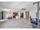 Bright, open living area with tile flooring, a ceiling fan, and adjoining dining and kitchen spaces at 4201 Globe Thistle Dr, Tampa, FL 33619
