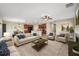 Spacious living room with ample seating, a ceiling fan, and an open layout to the kitchen at 4201 Globe Thistle Dr, Tampa, FL 33619
