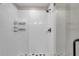 Elegant walk-in shower with clear glass doors, white tile, and modern fixtures at 4201 Globe Thistle Dr, Tampa, FL 33619