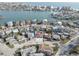 Aerial view of a coastal neighborhood with a mix of homes and a glimpse of the ocean at 440 S Bayshore Dr, Madeira Beach, FL 33708
