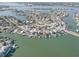 An aerial view showcasing waterfront homes with private docks in a beautiful coastal community at 440 S Bayshore Dr, Madeira Beach, FL 33708