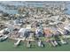 An aerial view showcasing waterfront homes with private docks in a coastal community at 440 S Bayshore Dr, Madeira Beach, FL 33708