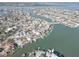 An aerial view of waterfront homes with private docks in a vibrant coastal community at 440 S Bayshore Dr, Madeira Beach, FL 33708