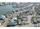 Aerial view showcasing a neighborhood with some houses having pools, in a coastal community at 440 S Bayshore Dr, Madeira Beach, FL 33708