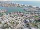 An aerial view of residential real estate along the water with city skyline in the background at 440 S Bayshore Dr, Madeira Beach, FL 33708