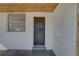 Rear entrance of the home featuring wooden ceiling and access to the backyard at 440 S Bayshore Dr, Madeira Beach, FL 33708