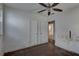 Bedroom features ceiling fan, and bare floors with two doors and window at 440 S Bayshore Dr, Madeira Beach, FL 33708