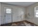 Small bedroom featuring a window and door to the exterior at 440 S Bayshore Dr, Madeira Beach, FL 33708