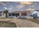Charming home featuring a cozy screened-in porch and a well-kept front yard at 440 S Bayshore Dr, Madeira Beach, FL 33708