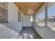 Spacious screened in front porch providing a shaded spot at 440 S Bayshore Dr, Madeira Beach, FL 33708