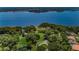 Scenic aerial view featuring a large lake surrounded by lush greenery and luxury homes at 4693 Aylesford Dr, Palm Harbor, FL 34685