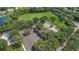 Aerial view showcasing the community park with a sports field, basketball court, parking lot, and playground at 4693 Aylesford Dr, Palm Harbor, FL 34685