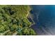 Aerial view of the property showcasing the lush landscaping and the pristine waterfront at 4693 Aylesford Dr, Palm Harbor, FL 34685