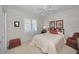 Bedroom with window shutters, a ceiling fan, and a bed with decorative pillows at 4693 Aylesford Dr, Palm Harbor, FL 34685