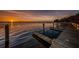Community dock with boat slips along the tranquil waterfront at sunset at 4693 Aylesford Dr, Palm Harbor, FL 34685