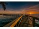 Community pier stretching out into calm waters under a vibrant sunset at 4693 Aylesford Dr, Palm Harbor, FL 34685