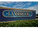 Prominent Lansbrook community sign set against a blue-tiled backdrop, complemented by neatly trimmed bushes at 4693 Aylesford Dr, Palm Harbor, FL 34685