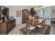 Dining room with wood furniture, decorative cabinet, and view of the landscaped yard at 4693 Aylesford Dr, Palm Harbor, FL 34685