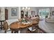 Dining space with an oval table, decorative chandelier, and view of the backyard pool at 4693 Aylesford Dr, Palm Harbor, FL 34685