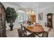 Formal dining room featuring a chandelier, arched windows, and classic furnishings at 4693 Aylesford Dr, Palm Harbor, FL 34685