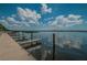 Picturesque view of a dock featuring multiple boat slips on a sunny day with a blue, cloudy sky at 4693 Aylesford Dr, Palm Harbor, FL 34685
