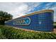 Lansbrook community entrance sign with tilework, landscaping, and blue sky at 4693 Aylesford Dr, Palm Harbor, FL 34685