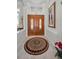 Elegant foyer with a decorative rug leading to stunning double doors with glass inserts at 4693 Aylesford Dr, Palm Harbor, FL 34685