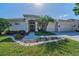 Stunning single-story home showcasing a well-manicured lawn and a double-door entrance at 4693 Aylesford Dr, Palm Harbor, FL 34685