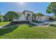 Charming single-story home boasting a lush green lawn and a welcoming double-door entrance at 4693 Aylesford Dr, Palm Harbor, FL 34685