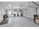 Spacious garage featuring epoxy flooring, ceiling fan, storage racks, and ample room for vehicles and projects at 4693 Aylesford Dr, Palm Harbor, FL 34685