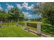 Lansbrook Lakefront Park sign surrounded by green lawn and trees, offering serene views and outdoor enjoyment at 4693 Aylesford Dr, Palm Harbor, FL 34685