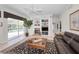 Spacious living room featuring a fireplace, built-ins, and access to the pool area at 4693 Aylesford Dr, Palm Harbor, FL 34685
