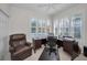 Office featuring a desk, an office chair, and an armchair with multiple windows at 4693 Aylesford Dr, Palm Harbor, FL 34685