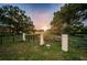 Lansbrook Lakefront Park sign surrounded by green grass and trees under a sunset at 4693 Aylesford Dr, Palm Harbor, FL 34685