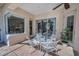 Covered patio with a glass table and white chairs, perfect for outdoor dining at 4693 Aylesford Dr, Palm Harbor, FL 34685