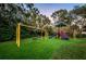 Vibrant community playground featuring swings, slides, and a playful design at 4693 Aylesford Dr, Palm Harbor, FL 34685