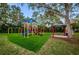 Colorful community playground with slides, swings, and picnic shelter at 4693 Aylesford Dr, Palm Harbor, FL 34685