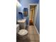 Bright bathroom featuring blue walls, a white vanity, and a tiled floor at 4801 Airport Rd # 118, Zephyrhills, FL 33542