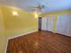 Spacious bedroom with wood floors, a ceiling fan, and large closets at 4801 Airport Rd # 118, Zephyrhills, FL 33542