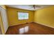 Sunny bedroom with wood flooring, a ceiling fan, and a window at 4801 Airport Rd # 118, Zephyrhills, FL 33542