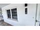 Exterior view of unit 118 featuring a well-lit entry and a secure door at 4801 Airport Rd # 118, Zephyrhills, FL 33542