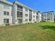 Exterior view of the building with well-maintained lawn and landscaping at 4801 Airport Rd # 118, Zephyrhills, FL 33542