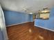 Spacious open-concept living area featuring hardwood flooring and seamless access to kitchen at 4801 Airport Rd # 118, Zephyrhills, FL 33542