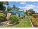 Landscaped backyard with flower beds, privacy fence, and well-maintained lawn at 500 45Th S St, St Petersburg, FL 33711