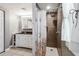 Bathroom features shower stall with glass surround, tiled walls, and white vanity at 500 45Th S St, St Petersburg, FL 33711