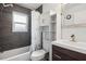 Cozy bathroom features a shower-tub combo, vanity with drawers, and white cabinet for storage at 500 45Th S St, St Petersburg, FL 33711
